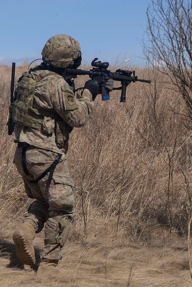 Senior Airman Joseph Stover, a convoy response force member assigned to the 791st Missile Security Forces Squadron, fires a Simunition round at the opposition force during a training exercise in Garrison, N.D., March 30, 2016. CRF Airmen participated in three iterations of training to prepare for the Air Force Global Strike Command Road Warrior. (U.S. Air Force photo/Airman 1st Class Jessica Weissman)