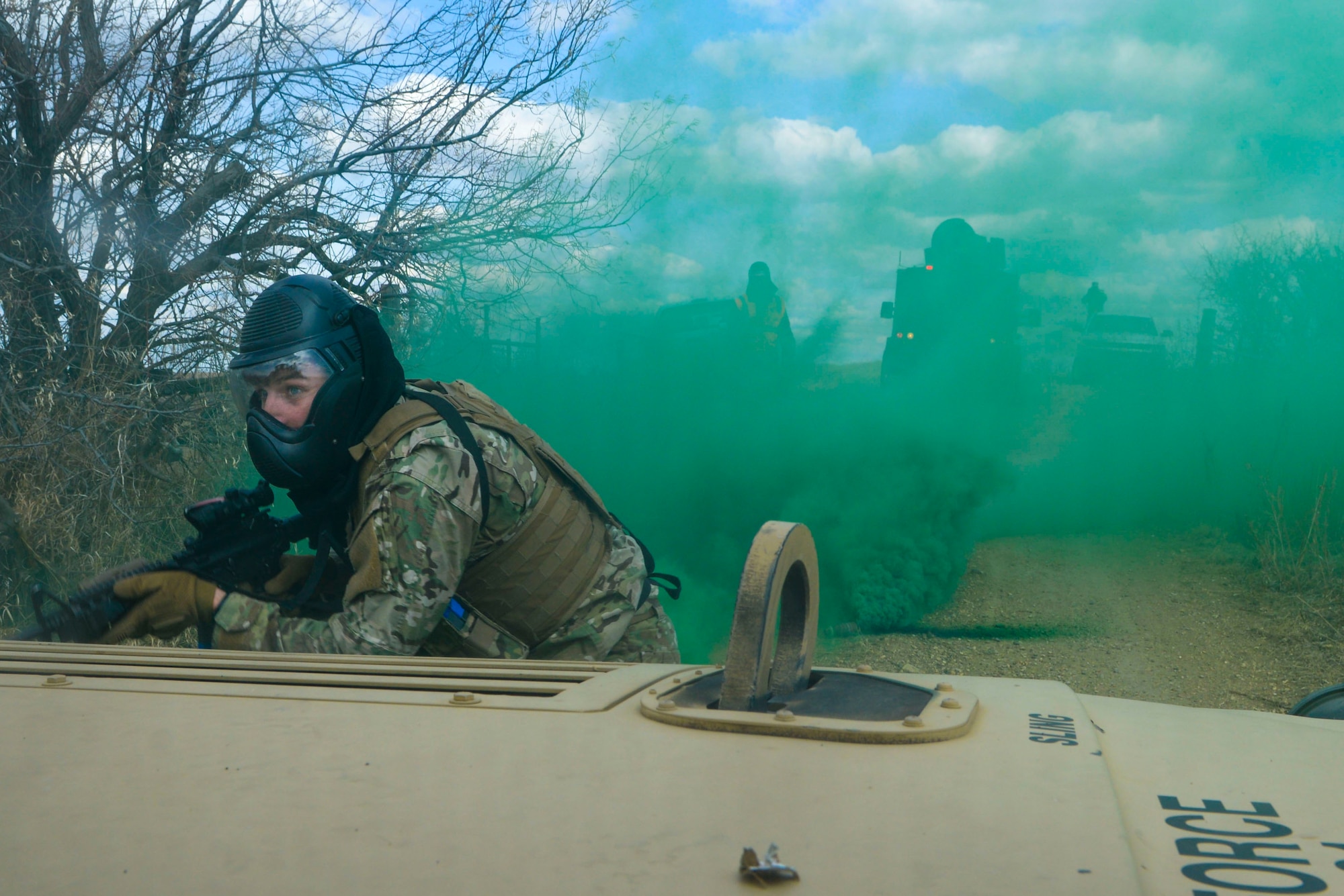 Senior Airman Zachary Crutchfield, a tactical response force member assigned to the 791st Missile Security Forces Squadron, attempts to capture the resource from a simulated payload transporter van. Crutchfield and other TRF members were acting as the opposition force during the three iterations of training to prepare convoy response force Airmen for the Air Force Global Strike Command Road Warrior exercise. (U.S. Air Force photo/Airman 1st Class Jessica Weissman)