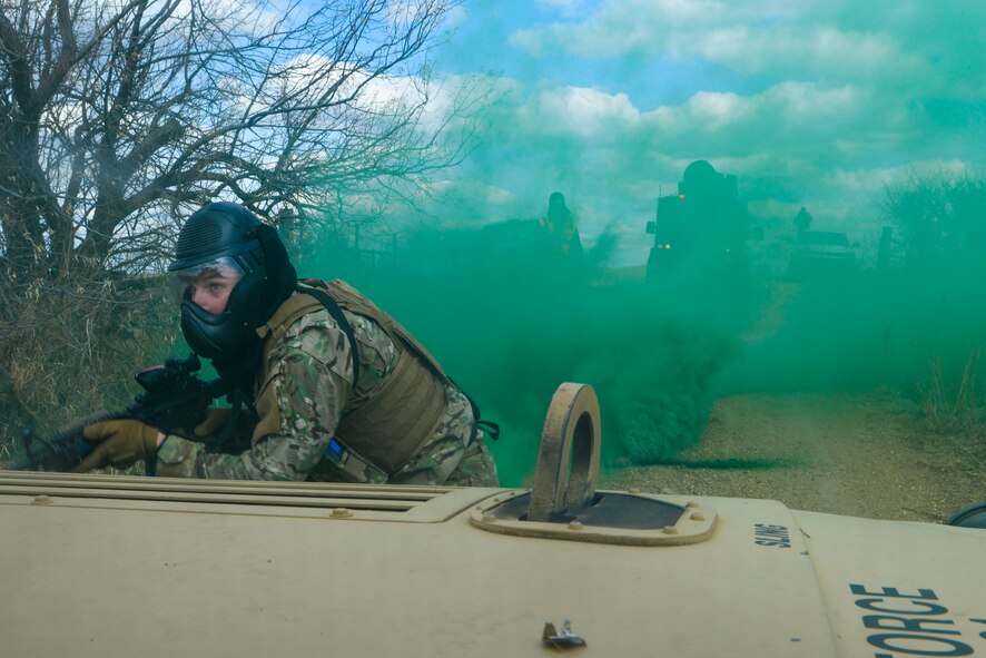Senior Airman Zachary Crutchfield, a tactical response force member assigned to the 791st Missile Security Forces Squadron, attempts to capture the resource from a simulated payload transporter van. Crutchfield and other TRF members were acting as the opposition force during the three iterations of training to prepare convoy response force Airmen for the Air Force Global Strike Command Road Warrior exercise. (U.S. Air Force photo/Airman 1st Class Jessica Weissman)