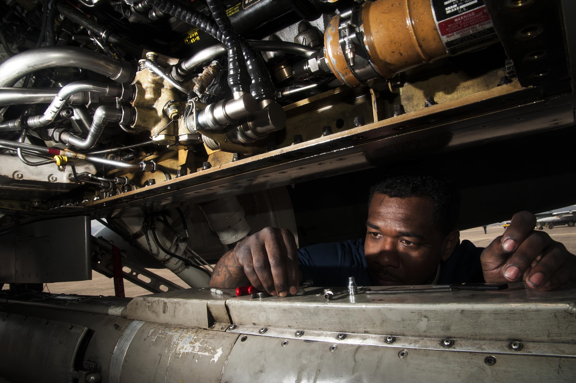 Staff Sgt. Decedrick Randle, 80th Aircraft Maintenance Unit electrical and environmental specialist, performs post flight maintenance during Buddy Wing 16-3 at Jungwon Air Base, ROK, March 30, 2016. Buddy Wing training, held multiple times a year, polishes the ability of the Republic of Korea and U.S. pilots to train and operate as a combined force. (U.S. Air Force photo by Staff Sgt. Nick Wilson/Released)