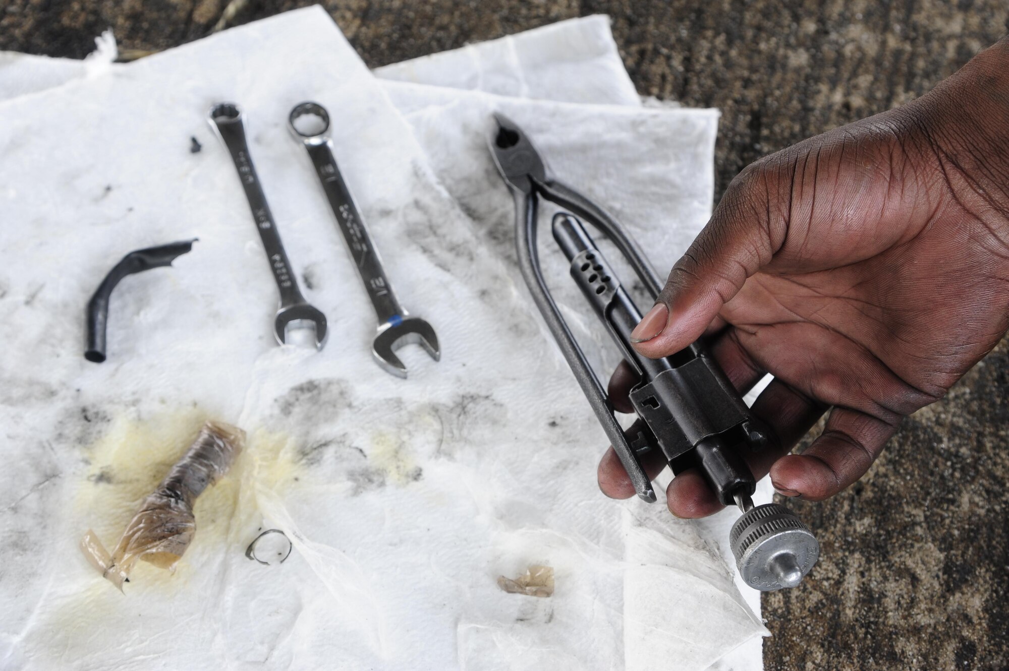 Staff Sgt. Decedrick Randle, 80th Aircraft Maintenance Unit electrical and environmental specialist, organizes tools to perform post-flight-maintenance during Buddy Wing 16-3 at Jungwon Air Base, ROK, March 30, 2016. Buddy Wing training, held multiple times a year, polishes the ability of the Republic of Korea and U.S. pilots to train and operate as a combined force. (U.S. Air Force photo by Staff Sgt. Nick Wilson/Released)