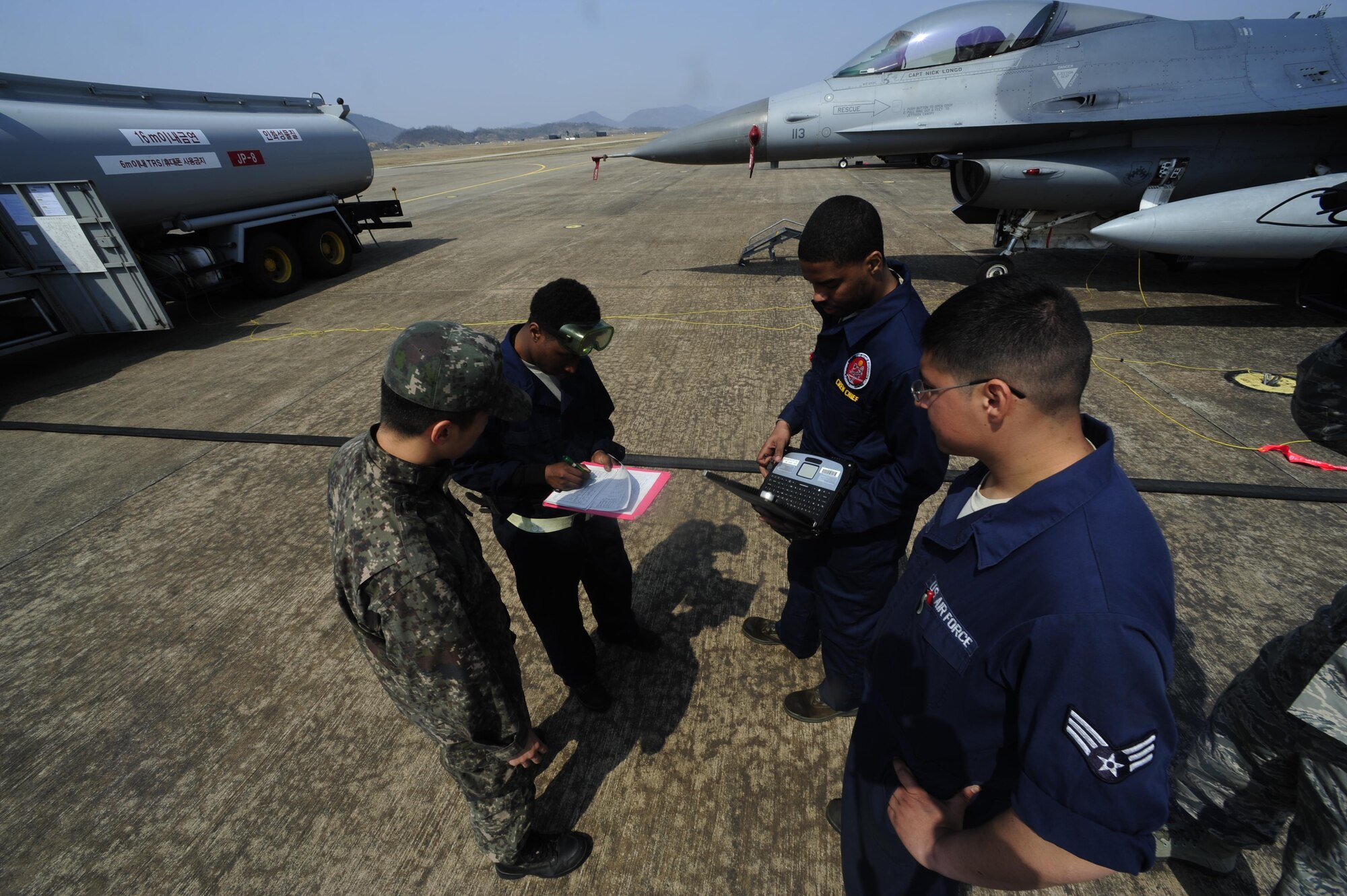 U.S. Air Force maintainers from the 80th Aircraft Maintenance Unit, Kunsan Air Base, Republic of Korea, and the Republic of Korea air force maintainers from the 19th Fighter Wing meet to sign paperwork during Buddy Wing 16-3 at Jungwon Air Base, Republic of Korea, March 30, 2016. Buddy Wing training, held multiple times a year, polishes the ability of the Republic of Korea and U.S. pilots to train and operate as a combined force. (U.S. Air Force photo by Staff Sgt. Nick Wilson/Released)