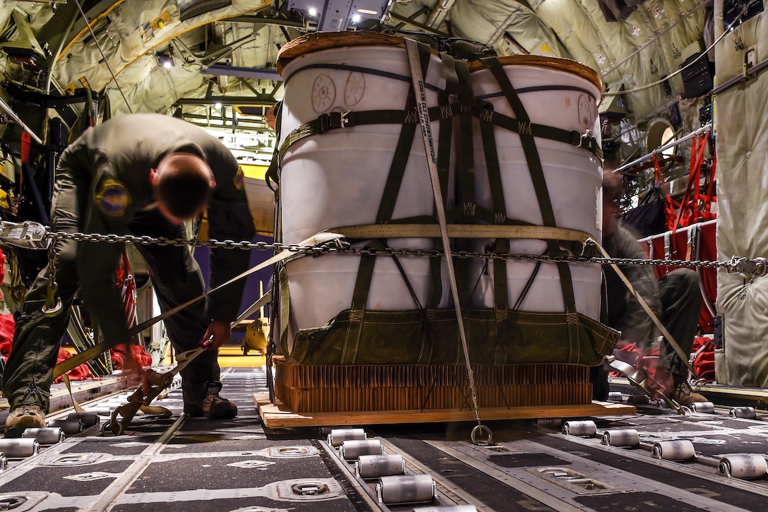 Airmen tie down simulated cargo to the floor of a C-130J Hercules aircraft during a training mission at Dyess Air Force Base, Texas, March 30, 2016. Air Force photo by Senior Airman Keith James