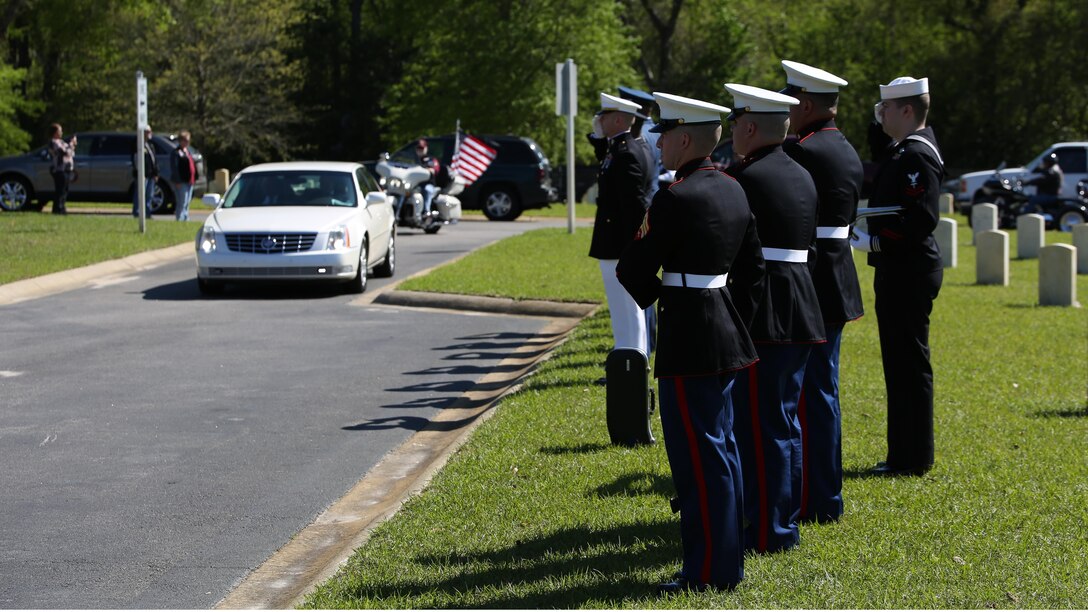 Service members salute the funeral cascade for Sgt. John Holladay, a World War II Marine Raider who was killed in action in 1943, as they drive into the National Cemetery in Florence, S.C., where Holladay was laid to rest April 4, 2016. During World War II, Holladay was assigned to Company B, 1st Marine Raider Battalion, 1st Marine Raider Regiment, who fought battles against Japanese positions along the Pacific front where he was killed.