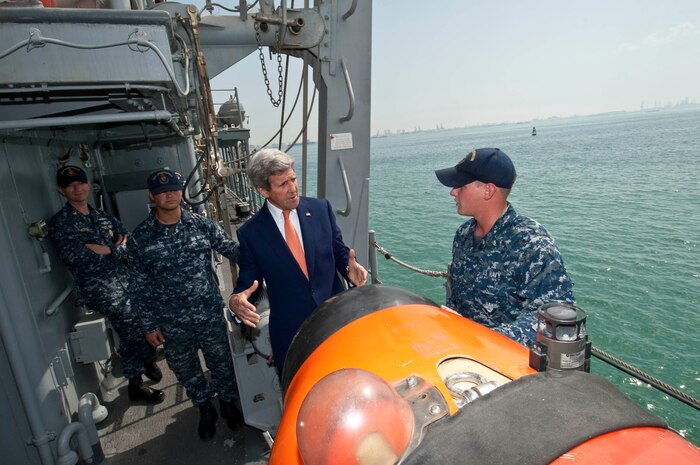 (April 07, 2016) U.S. Secretary of State John Kerry speaks with Mineman Seaman Austin Nichols aboard the Avenger-class Mine Countermeasures ship USS Devastator (MCM 6) during a visit to Naval Support Activity Bahrain. The secretary visited Sailors of the U.S. 5th Fleet as part of his current travel to the region.