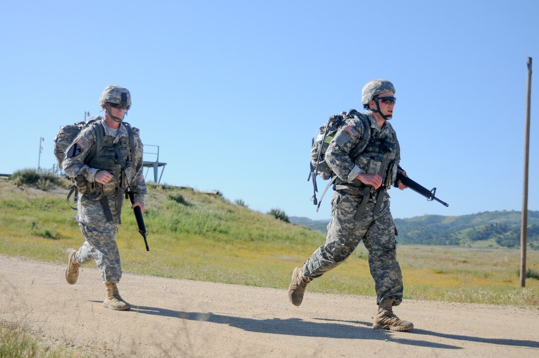 Soliders test their endurance during a ruck march at the U.S. Army Civil Affairs and Psychological Operations Command 2016 U.S. Army Best Warrior Competition at Fort Hunter Liggett, Calif., April 5, 2016. This year’s Best Warrior competition will determine the top noncommissioned officer and junior enlisted Soldier who will represent USACAPOC in the Army Reserve Best Warrior competition later this year. (U.S. Army photo by Spc. Khadijah Lutz-Wilcox, USACAPOC)
