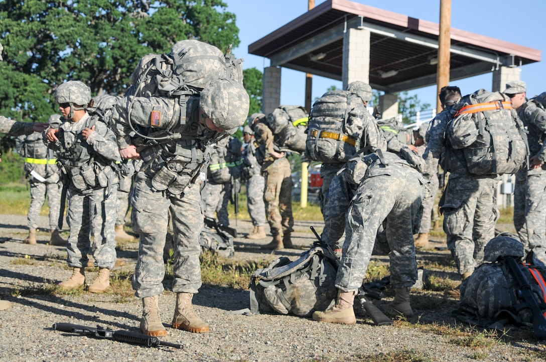 Soldiers prepare to compete in a ruck march at the U.S. Army Civil Affairs and Psychological Operations Command 2016 U.S. Army Best Warrior Competition at Fort Hunter Liggett, Calif., April 5, 2016. This year’s Best Warrior competition will determine the top noncommissioned officer and junior enlisted Soldier who will represent USACAPOC in the Army Reserve Best Warrior competition later this year. (U.S. Army photo by Spc. Khadijah Lutz-Wilcox, USACAPOC)