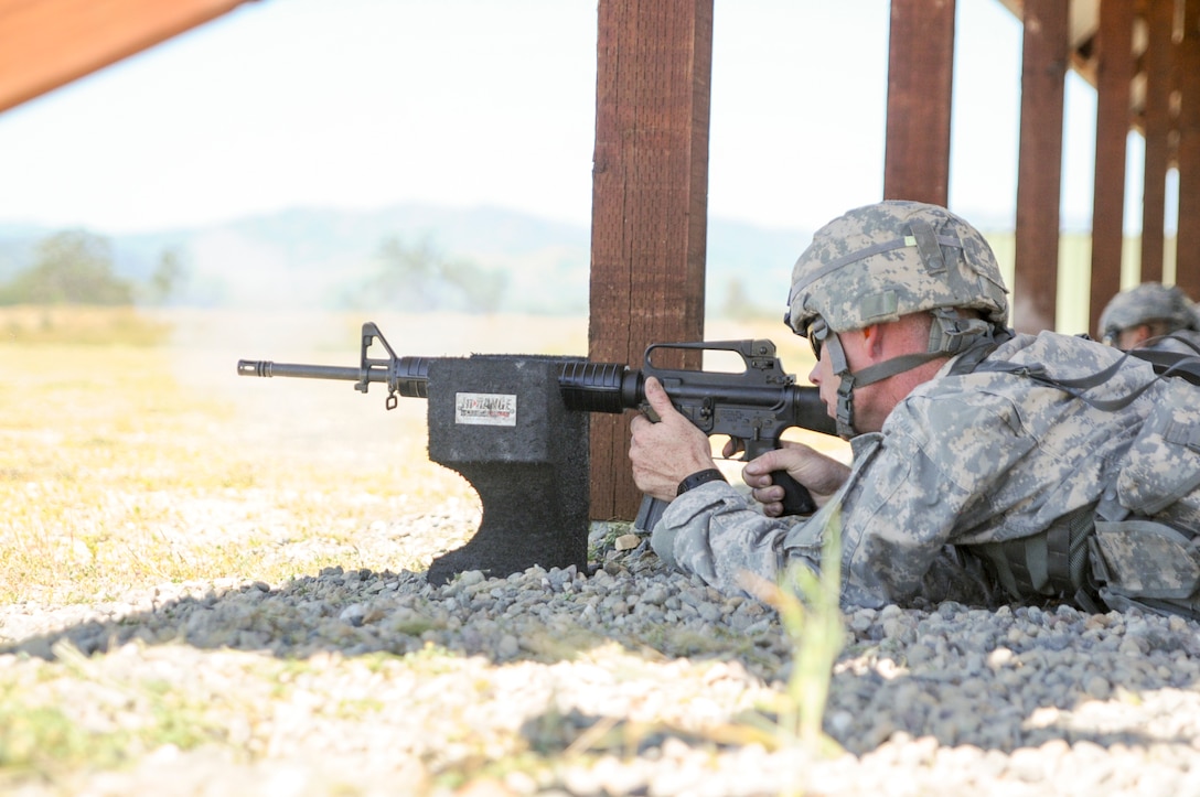 A Soldier fires a rifle at the U.S. Army Civil Affairs and Psychological Operations Command 2016 U.S. Army Best Warrior Competition at Fort Hunter Liggett, Calif., April 5, 2016. This year’s Best Warrior competition will determine the top noncommissioned officer and junior enlisted Soldier who will represent USACAPOC in the Army Reserve Best Warrior competition later this year. (U.S. Army photo by Spc. Khadijah Lutz-Wilcox, USACAPOC)
