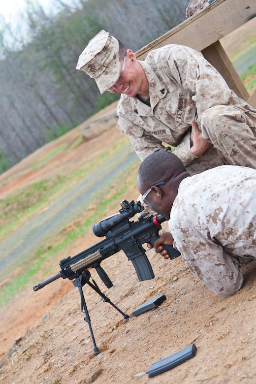 Cpl. Arryor Olijones, Marine Corps Combat Development Command motor transportation operator, recieves training from Cpl. Lawrence Manton during a weapons familiarization firing course at Weapons Training Battalion.