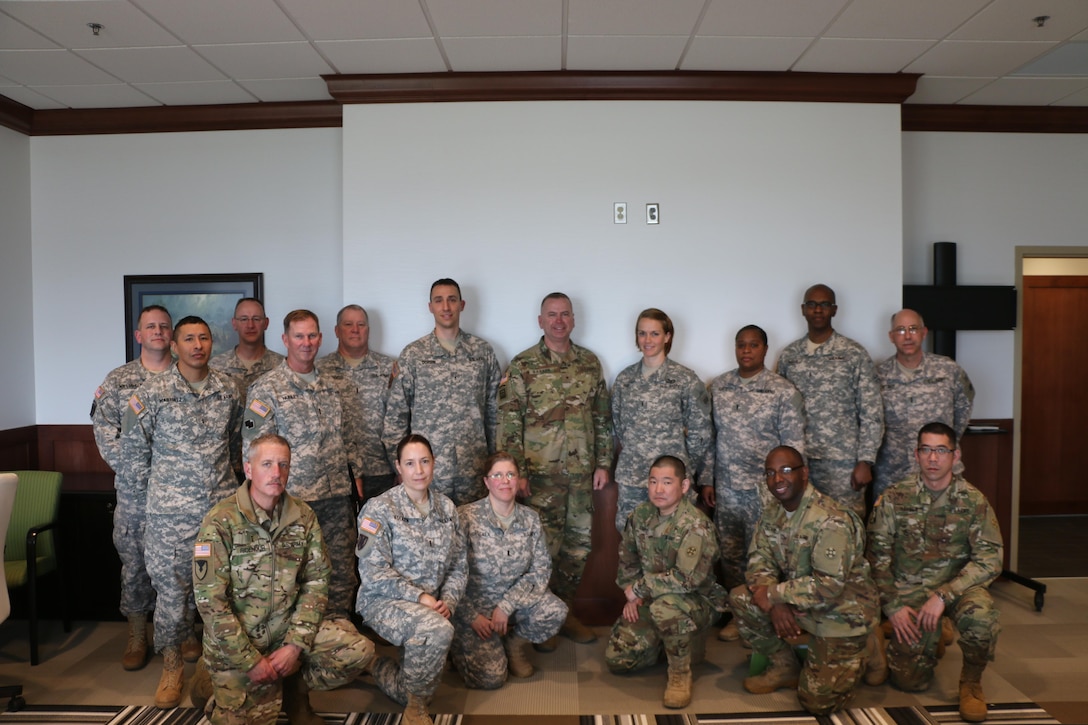 Army Reserve warrant officers from the 310th Sustainment Command (Expeditionary) meet with Brig. Gen. Vincent B. Barker for introductions and to brief him on warrant officer priorities and job specialties at the SPC Luke P. Frist Army Reserve Center, Ind., March 20, 2016.