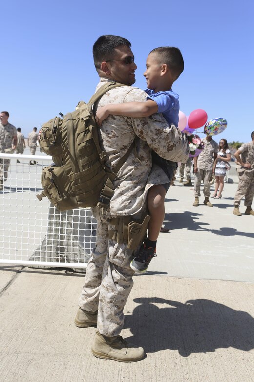 A Marine returning from deployment reunites with his son aboard Marine Corps Air Station Miramar, Calif., April 4. Service members from Marine Wing Support Squadron (MWSS) 372, Marine Medium Tiltrotor Squadron (VMM) 363 and Marine Aviation Logistics Squadron (MALS) 16 returned from a six and a half month deployment with the Special Purpose Marine Air-Ground Task Force – Crisis Response – Central Command in support of Operation Inherent Resolve. (U.S. Marine Corps photo by Lance Cpl. Harley Robinson/Released)