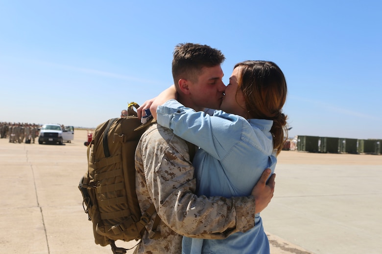 A Marine returning from deployment embraces his girlfriend aboard Marine Corps Air Station Miramar, Calif., April 4. Service members from Marine Wing Support Squadron (MWSS) 372, Marine Medium Tiltrotor Squadron (VMM) 363 and Marine Aviation Logistics Squadron (MALS) 16 returned from a six and a half month deployment with the Special Purpose Marine Air-Ground Task Force – Crisis Response – Central Command in support of Operation Inherent Resolve. (U.S. Marine Corps photo by Lance Cpl. Harley Robinson/Released)