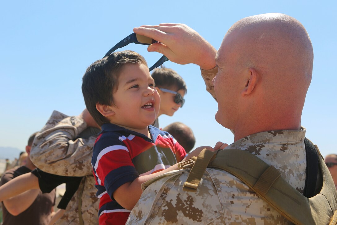 A Marine returning from deployment reunites with his son aboard Marine Corps Air Station Miramar, Calif., April 4. Service members from Marine Wing Support Squadron (MWSS) 372, Marine Medium Tiltrotor Squadron (VMM) 363 and Marine Aviation Logistics Squadron (MALS) 16 returned from a six and a half month deployment with the Special Purpose Marine Air-Ground Task Force – Crisis Response – Central Command in support of Operation Inherent Resolve. (U.S. Marine Corps photo by Lance Cpl. Harley Robinson/Released)