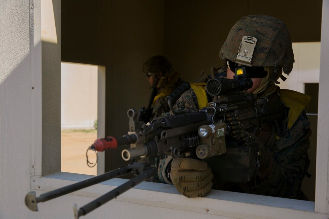 A Marine with Company B, 1st Battalion, 4th Marines, provides security with his M249 Squad Automatic Weapon as fellow Marines clear buildings during a Marine Corps Combat Readiness Evaluation aboard Marine Corps Base Camp Pendleton, Calif., March 29, 2016. The M249 SAW is the fire team’s maneuverable automatic weapon, providing Marines with the ability to quickly gain and maintain fire superiority over the enemy. (U.S. Marine Corps photo by Lance Cpl. Timothy Valero/ Released)
