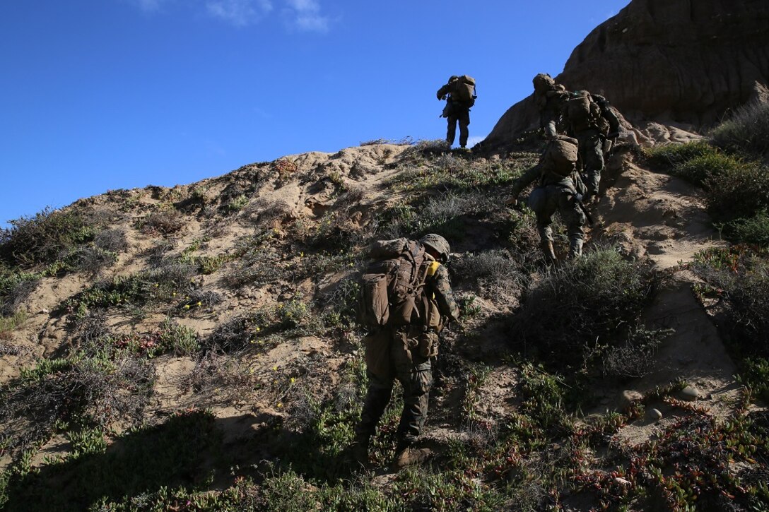 Marines with Company B, 1st Battalion, 4th Marines, patrol the area after an amphibious landing during a Marine Corps Combat Readiness Evaluation aboard Marine Corps Base Camp Pendleton, Calif., March 29, 2016. Marines traversed the steep terrain making their way to a combat town training area where they honed their urban assault techniques. (U.S. Marine Corps photo by Lance Cpl. Timothy Valero/ Released) GREAT SHOT!