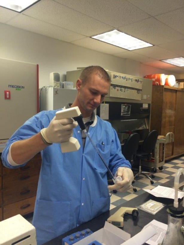 Capt. Christopher Ecker, a chemical officer assigned to the 307th Medical Brigade and a microbiologist for the U. S. Geological Survey Ohio Water Center, analyzes algal toxins at the USGS Ohio Water Microbiology Lab in Columbus, Ohio.