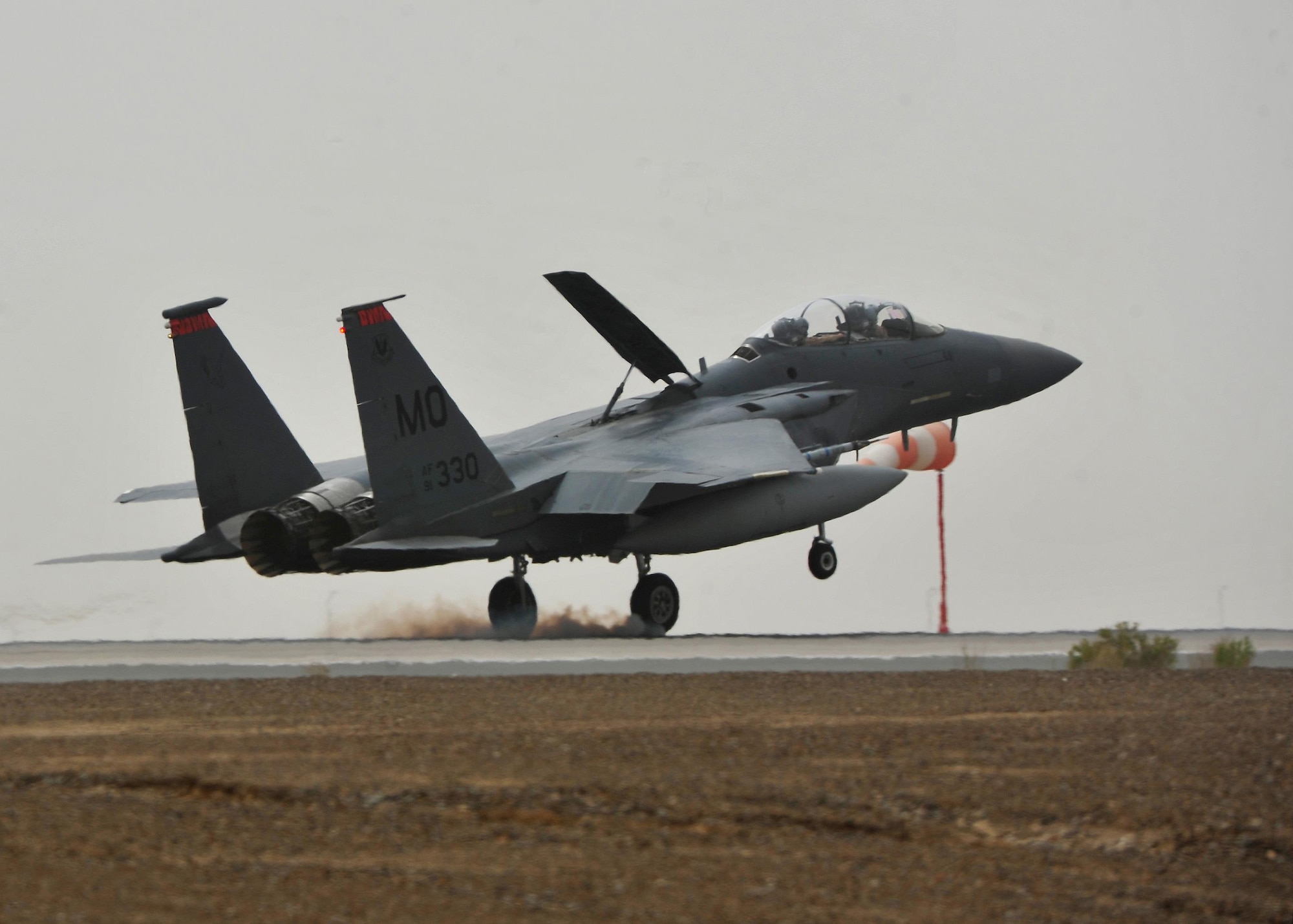 An F-15E Strike Eagle aircraft touches down during Exercise Desert Flag March 30, 2016, at an undisclosed location in Southwest Asia. When pilots weren’t flying sorties during the exercise, they were planning with their crews and coalition partners, discussing what capabilities everyone brought to the team before heading out for their next mission. (U.S. Air Force photo by Staff Sgt. Kentavist P. Brackin/released)
