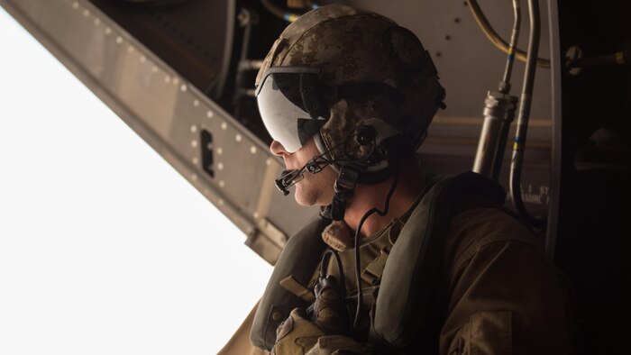 Sgt. Sean Machale, a crew chief with Marine Medium Tiltrotor Squadron 161 “Greyhawks”, looks out of an MV-22B Osprey while performing a confined area landing with VMM-165 “White Knights” in Southern California, March 30, 2016. Marines with VMM-161 also conducted a division-formation flight with Marines from VMM-165, which helped to build interoperability and rapport between the squadrons.