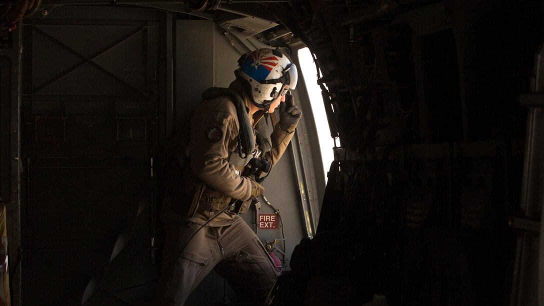 Cpl. Alec Bechtel, a crew chief with Marine Medium Tiltrotor Squadron 161 “Greyhawks”, monitors the distance of nearby aircraft during a confined area landing with Marines from VMM-165 in Southern California, March 30 2016. The training enabled Marines with VMM-161 to build interoperability between squadrons and maintain the proficiency of pilots and aircrew for these maneuvers.