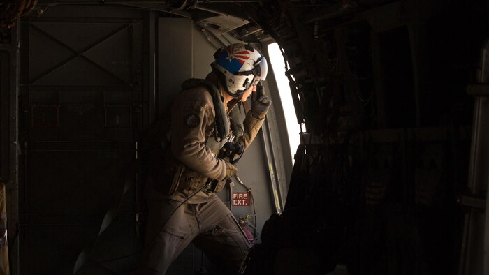 Cpl. Alec Bechtel, a crew chief with Marine Medium Tiltrotor Squadron 161 “Greyhawks”, monitors the distance of nearby aircraft during a confined area landing with Marines from VMM-165 in Southern California, March 30 2016. The training enabled Marines with VMM-161 to build interoperability between squadrons and maintain the proficiency of pilots and aircrew for these maneuvers.