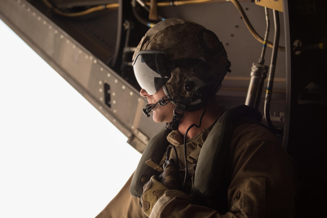 Sgt. Sean Machale, a crew chief with Marine Medium Tiltrotor Squadron (VMM) 161 “Greyhawks” and a San Diego native, looks out of an MV-22B Osprey while performing a confined area landing with VMM-165 “White Knights” in Southern California, March 30. Marines with VMM-161 also conducted a division-formation flight with Marines from VMM-165, which helped to build interoperability and rapport between the squadrons. (U.S. Marine Corps photo by Sgt. Lillian Stephens/Released)
