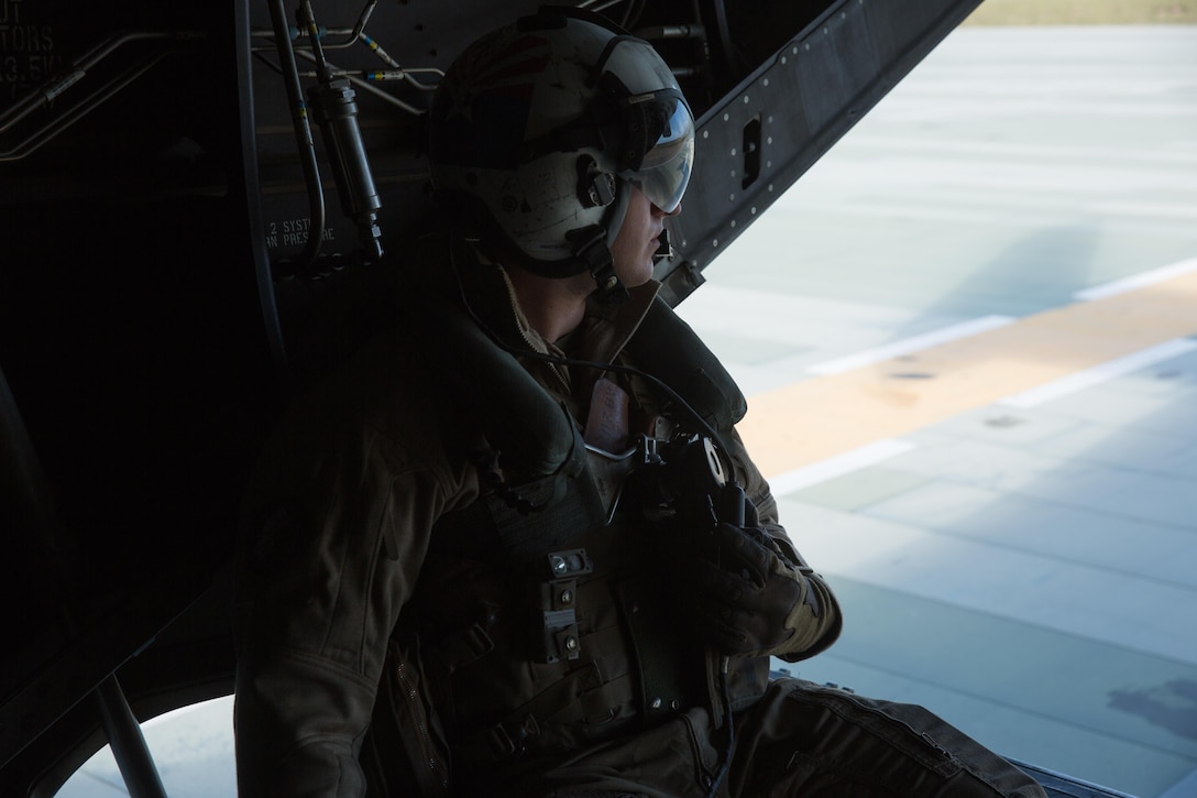 Cpl. Alec Bechtel, a crew chief with Marine Medium Tiltrotor Squadron (VMM) 161 and a Mesa, Ariz., native, communicates with pilots during a field carrier landing practice aboard Marine Corps Base Camp Pendleton, Calif., March 30. Marines with VMM-161 conducted field carrier landing practices aboard Camp Pendleton to maintain their proficiency in landing aboard Navy vessels. (U.S. Marine Corps photo by Sgt. Lillian Stephens/Released)