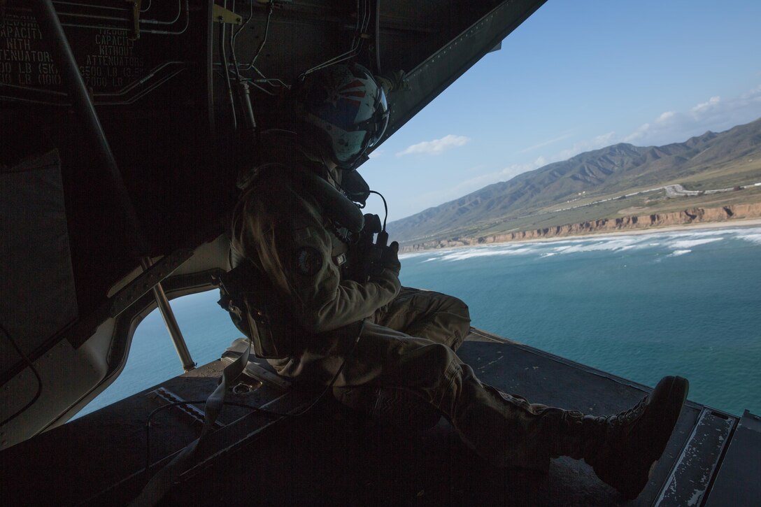 Cpl. Alec Bechtel, a crew chief with Marine Medium Tiltrotor Squadron (VMM) 161 and a Mesa, Ariz., native, communicates with pilots during a field carrier landing practice aboard Marine Corps Base Camp Pendleton, Calif., March 30. Marines with VMM-161 conducted field carrier landingyig practices aboard Camp Pendleton to maintain their proficiency in landing aboard Navy vessels. (U.S. Marine Corps photo by Sgt. Lillian Stephens/Released)