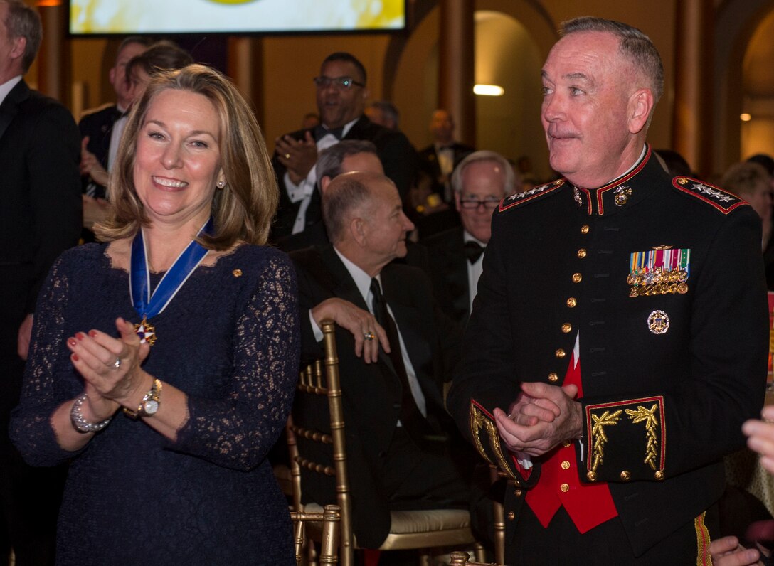 Bonnie Carroll, founder and president of Tragedy Assistance Program for Survivors, and Marine Gen. Joe Dunford, chairman of the Joint Chiefs of Staff, applaud at the TAPS 2016 Honor Guard Gala in Washington, D.C., April 6, 2016. DoD photo by Navy Petty Officer 2nd Class Jesse A. Hyatt