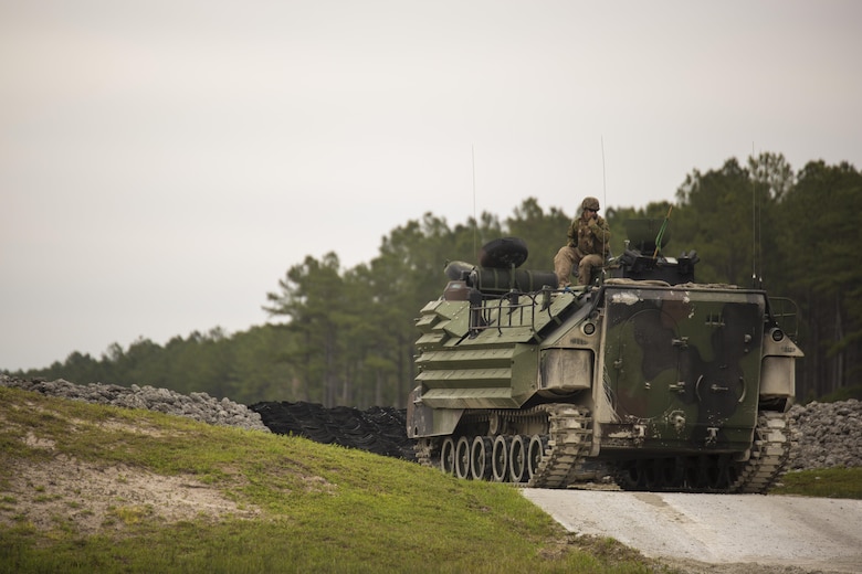 Cpl. Trevor Dodson, a vehicle commander with 2nd Assault Amphibian Battalion, communicates with range control to begin qualifying with an Amphibious Assault Vehicle during Heavy Brigade Combat Team training at Camp Lejeune, N.C., April 5, 2016. The unit conducts this type of training semi-annually to ensure all their Marines meet the requirements to successfully engage the enemy in a deployed environment. (U.S. Marine Corps photo by Cpl. Samuel Guerra/Released)