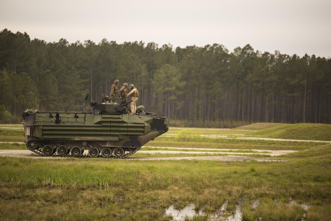 Marines with 2nd Assault Amphibian Battalion inspect their Amphibious Assault Vehicle prior to conducting a qualification course during Heavy Brigade Combat Team training at Camp Lejeune, N.C., April 5, 2016. The AAV provides other units with accurate suppression and supports maneuver elements for infantry units operating overseas. (U.S. Marine Corps photo by Cpl. Samuel Guerra/Released)