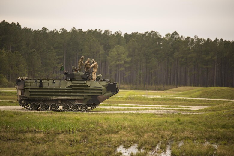 Marines with 2nd Assault Amphibian Battalion inspect their Amphibious Assault Vehicle prior to conducting a qualification course during Heavy Brigade Combat Team training at Camp Lejeune, N.C., April 5, 2016. The AAV provides other units with accurate suppression and supports maneuver elements for infantry units operating overseas. (U.S. Marine Corps photo by Cpl. Samuel Guerra/Released)