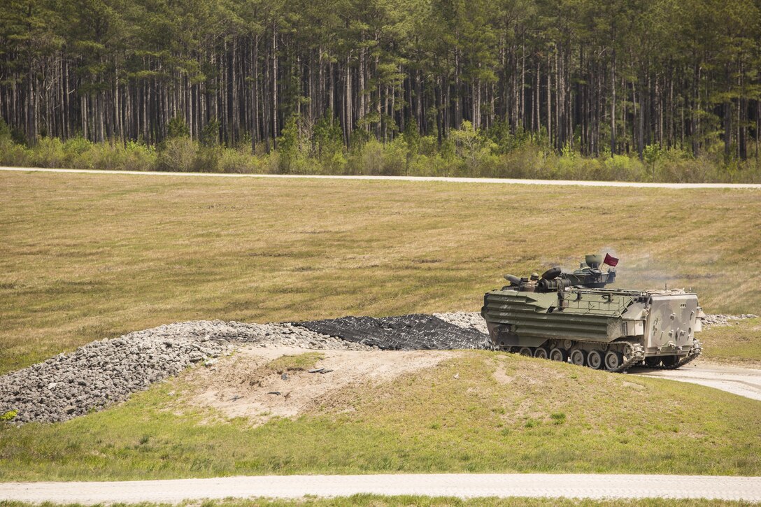 An Amphibious Assault Vehicle with 2nd Assault Amphibian Battalion engages simulated enemy targets during a qualification course during Heavy Brigade Combat Team training at Camp Lejeune, N.C., April 5, 2016. The training allows the unit to strengthen their working relationship and maintain weapons proficiency to remain being a reliable asset for amphibious operations. (U.S. Marine Corps photo by Cpl. Samuel Guerra/Released)