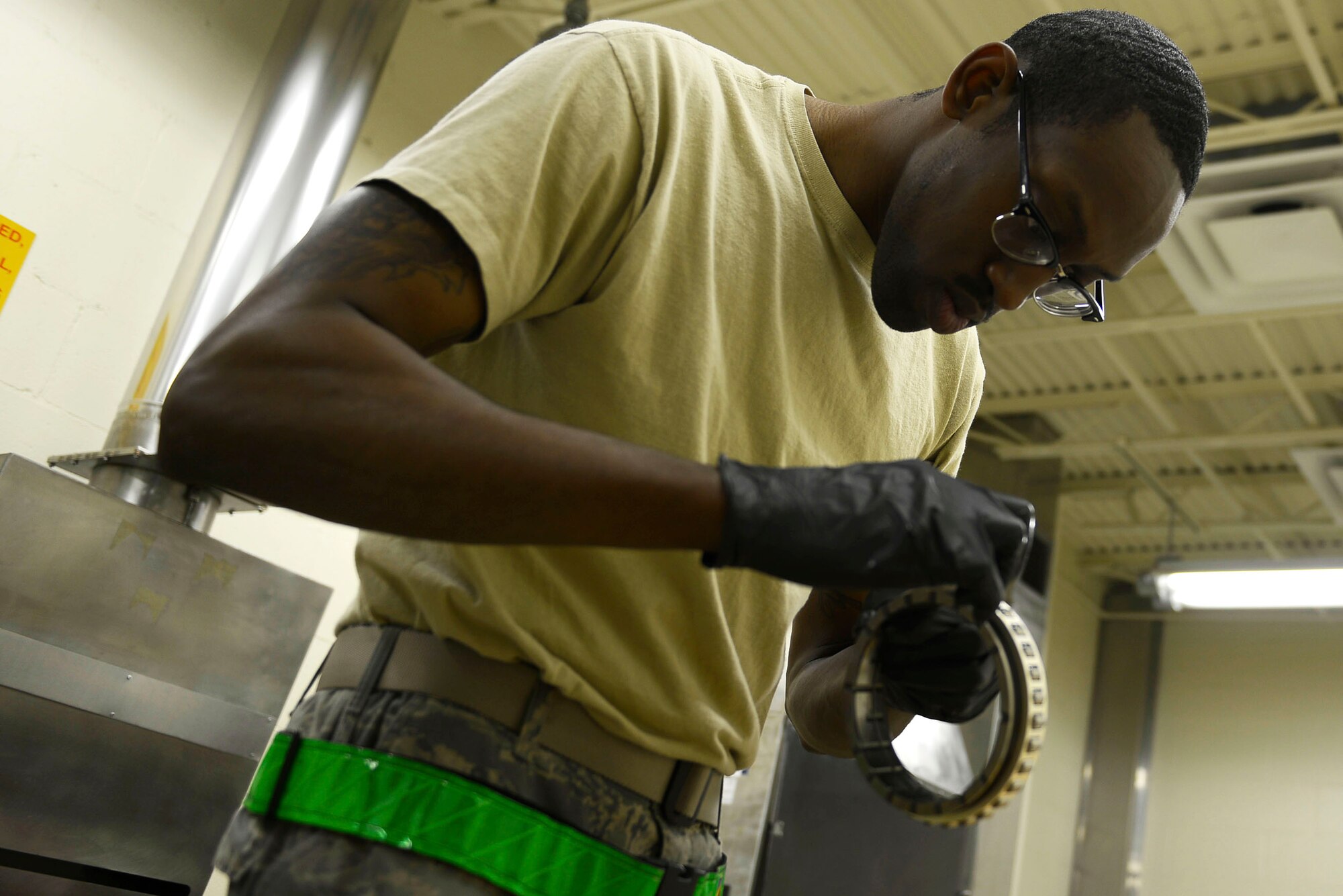 U.S. Air Force Staff Sgt. Andre Ingram, 20th Component Maintenance Squadron aerospace propulsion craftsman, examines a roller bearing for damages at Shaw Air Force Base, S.C., March 29, 2016. The careful inspection and lubrication of the bearing helps detect any damages and allows for a safe application onto the F-16CM Fighting Falcon engine. (U.S. Air Force photo by Airman 1st Class Christopher Maldonado)