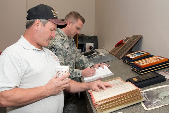 Retired U.S. Air Force Staff Sgt. D. L. Thompson, checks for his name on an Outstanding Tactical Airlift Squadron of the Year 1986, nomination letter during the “Red Devil Reunion” for the 50th Airlift Squadron at Little Rock Air Force Base, Ark., Apr. 1, 2016. Thompson retire in July 2001. (U.S. Air Force photo by Master Sgt. Jeff Walston/Released) 
