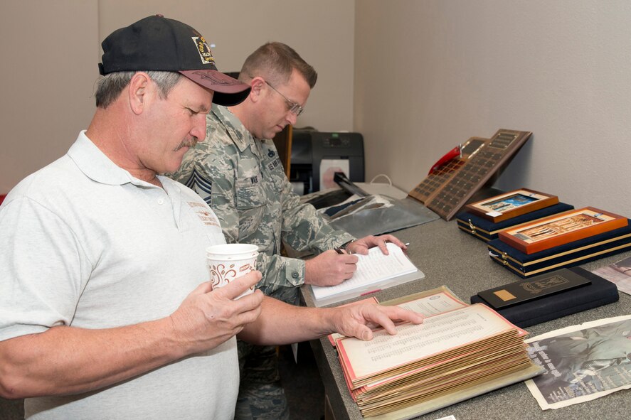 Retired U.S. Air Force Staff Sgt. D. L. Thompson, checks for his name on an Outstanding Tactical Airlift Squadron of the Year 1986, nomination letter during the “Red Devil Reunion” for the 50th Airlift Squadron at Little Rock Air Force Base, Ark., Apr. 1, 2016. Thompson retire in July 2001. (U.S. Air Force photo by Master Sgt. Jeff Walston/Released) 
