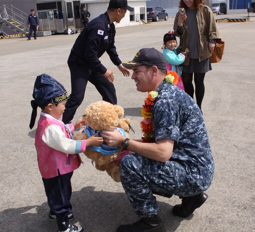 160406-N-WO381-023 CHINHAE, Republic of Korea (April 06, 2016)  Cmdr. Michael Beckette, commanding officer of USS Tucson (SSN 770) gives a teddy bear to a local child during a gift exchange. Homeported in Pearl Harbor, USS Tucson is the 59th Los Angeles-class attack submarine and the 30th of the Improved Los Angeles-class attack submarines to be built. (U.S. Navy photo by Master-at-Arms 3rd Class Diamond Brown/RELEASED)