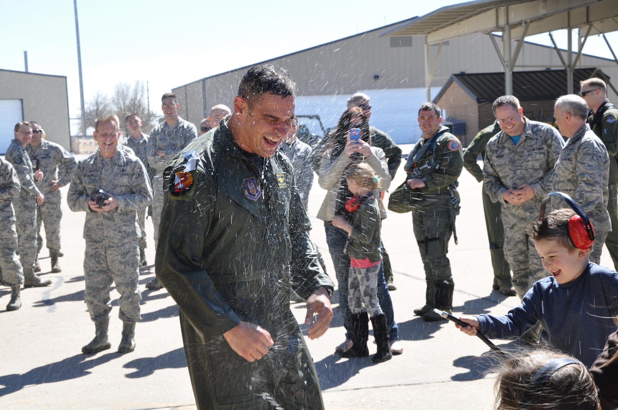 Col. David Castaneda, 419th Fighter Wing pilot, gets a cold welcome from his six-year-old son, Ryan, after taking his final flight in the F-16 Fighting Falcon at Hill Air Force Base, Utah, April 2. (U.S. Air Force photo/Tech. Sgt. Nathan Campbell) 