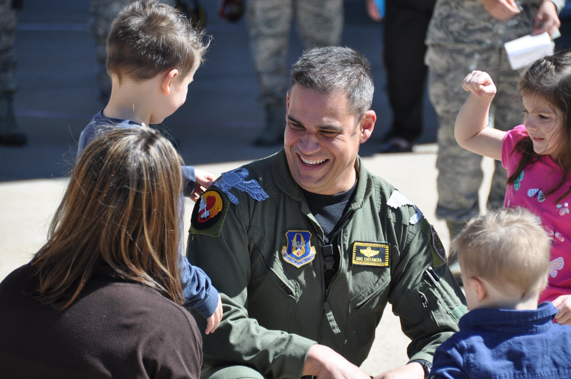 Col. David Castaneda, 419th Fighter Wing pilot, receives eagle insignia from his wife and children during an informal promotion ceremony following his final flight in the F-16 Fighting Falcon at Hill Air Force Base, Utah, April 2. (U.S. Air Force photo/Airman 1st Class Justin Fuchs)