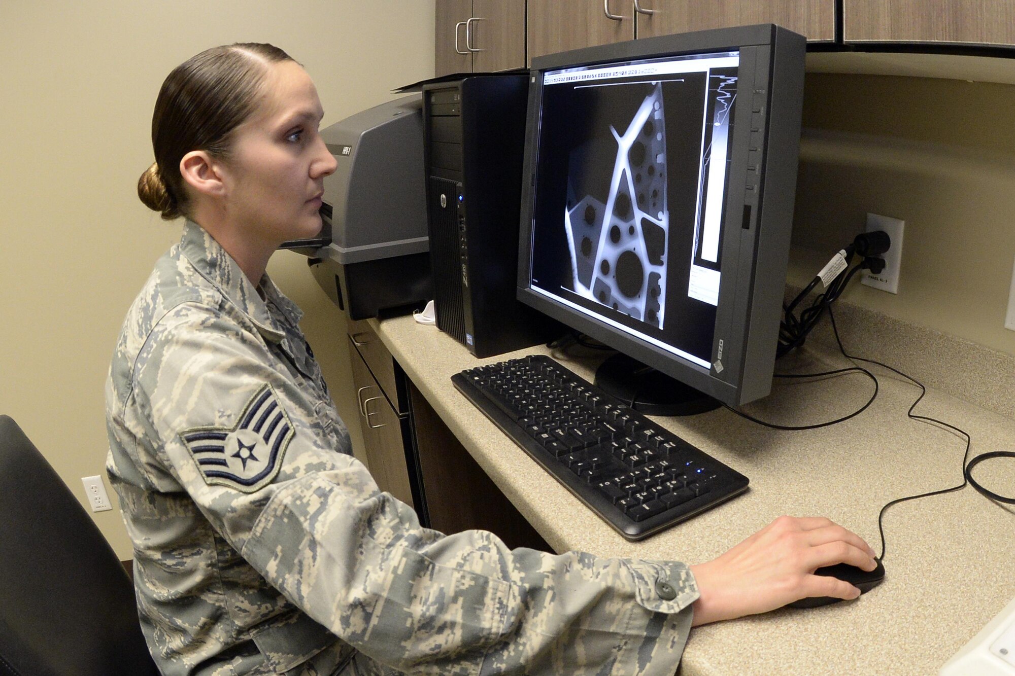 Staff Sgt. Cinnamon Kavlick, 388th Equipment Maintenance Squadron, inspects an X-ray image March 25 in the 388th EMS Non-Destructive Inspection laboratory at Hill Air Force Base, Utah. The 388th EMS NDI lab recently upgraded its radiography equipment with digital capabilities, improving the process of locating small cracks and identifying minute discontinuities in aircraft engines, wings, and other components. (U.S. Air Force photo by Todd Cromar)