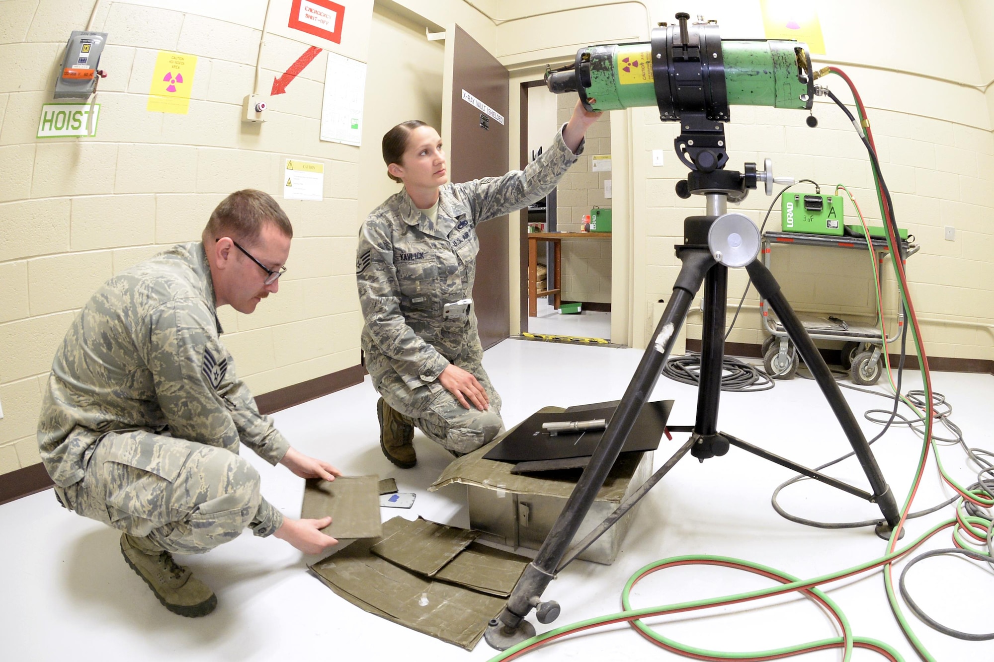 Staff Sgts. Joshua Batman and Cinnamon Kavlick, both assigned to the 388th Equipment Maintenance Squadron, prepare a tube head, lead screens, and digital back to scan a weld certification March 25 in their Nondestructive Inspection laboratory at Hill Air Force Base, Utah. The 388th EMS NDI lab recently upgraded its radiography equipment with digital capabilities, which will save time and money while creating a healthier work environment and eliminating hazardous wastes. (U.S. Air Force photo by Todd Cromar)