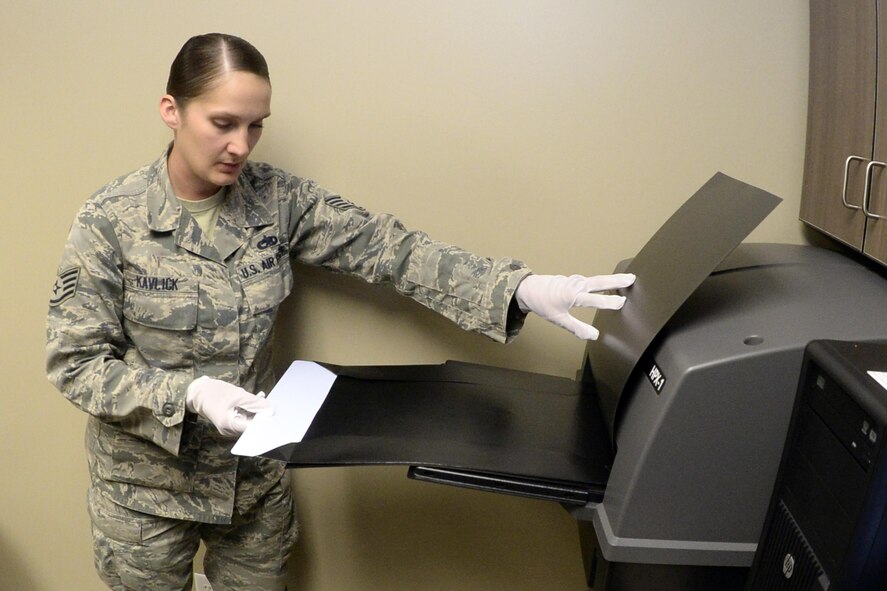 Staff Sgt. Cinnamon Kavlick, 388th Equipment Maintenance Squadron, inserts a digital imaging plate to be scanned March 25 in the 388th EMS Non-Destructive Inspection laboratory at Hill Air Force Base, Utah. The 388th EMS NDI lab recently upgraded its radiography equipment with digital capabilities, improving the process of locating small cracks and identifying minute discontinuities in aircraft engines, wings, and other components. (U.S. Air Force photo by Todd Cromar)