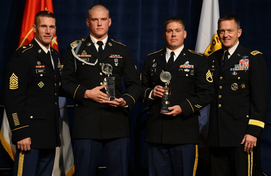 Sgt. Maj. of the Army Daniel A. Dailey, far left, and Army Vice Chief of Staff Gen. Daniel B. Allyn, far right, present the Soldier of the Year award to Spc. Jared R. Tansley, assigned to U.S. Army Europe, and the Noncommissioned Officer of the Year award to Staff Sgt. Andrew Fink, assigned to U.S. Army Reserve Command, during the 2015 Best Warrior Competition Awards Ceremony at the annual meeting of the Association of the United States Army in Washington, Oct. 12, 2015.