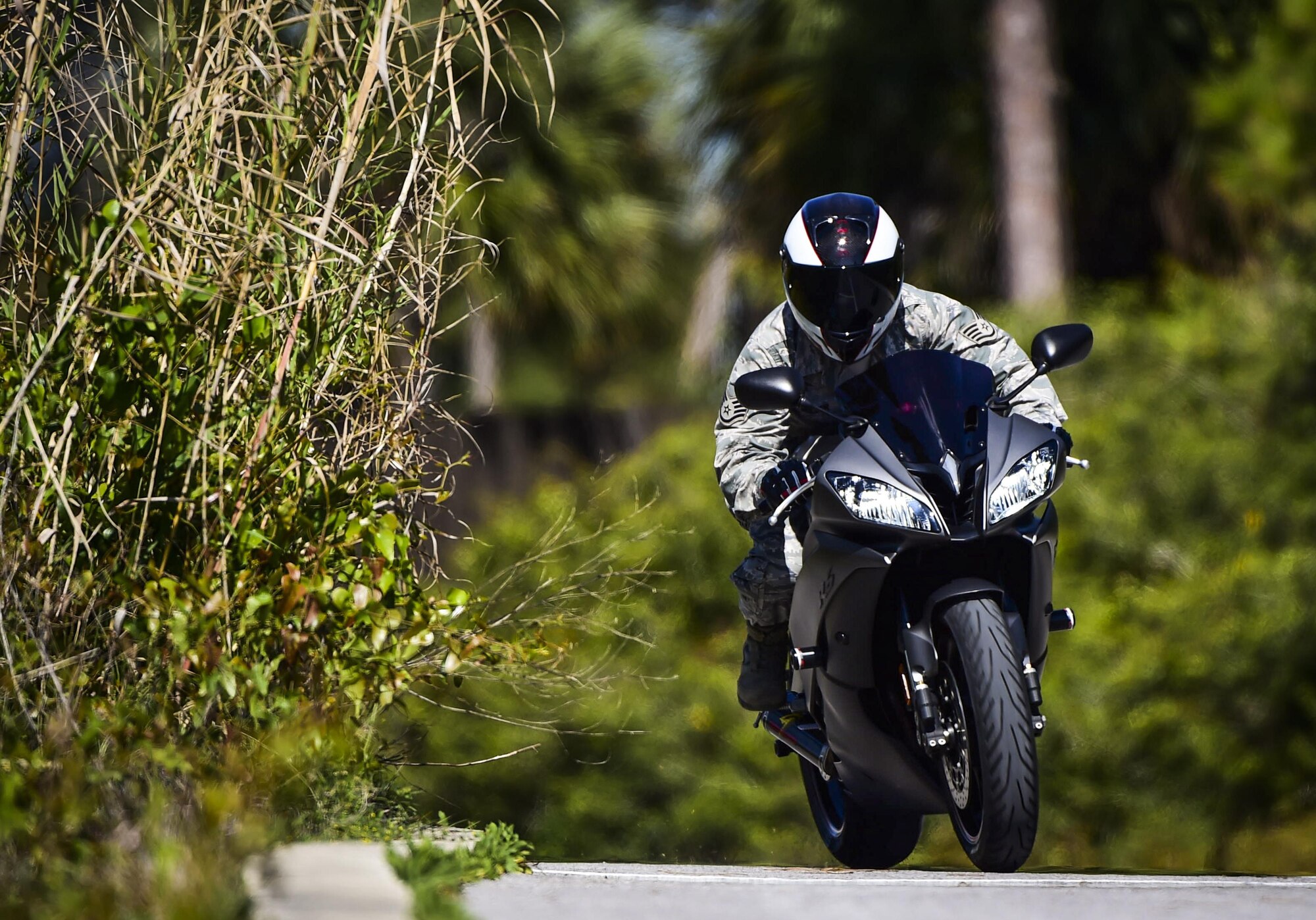 Staff Sgt. Marleah Miller, a photojournalist with the 1st Special Operations Wing Public Affairs, rides her 2013 Yamah R6 motorcycle at Hurlburt Field, Fla., April 7, 2016. (U.S. Air Force photo by Staff Sgt. Christopher Callaway)