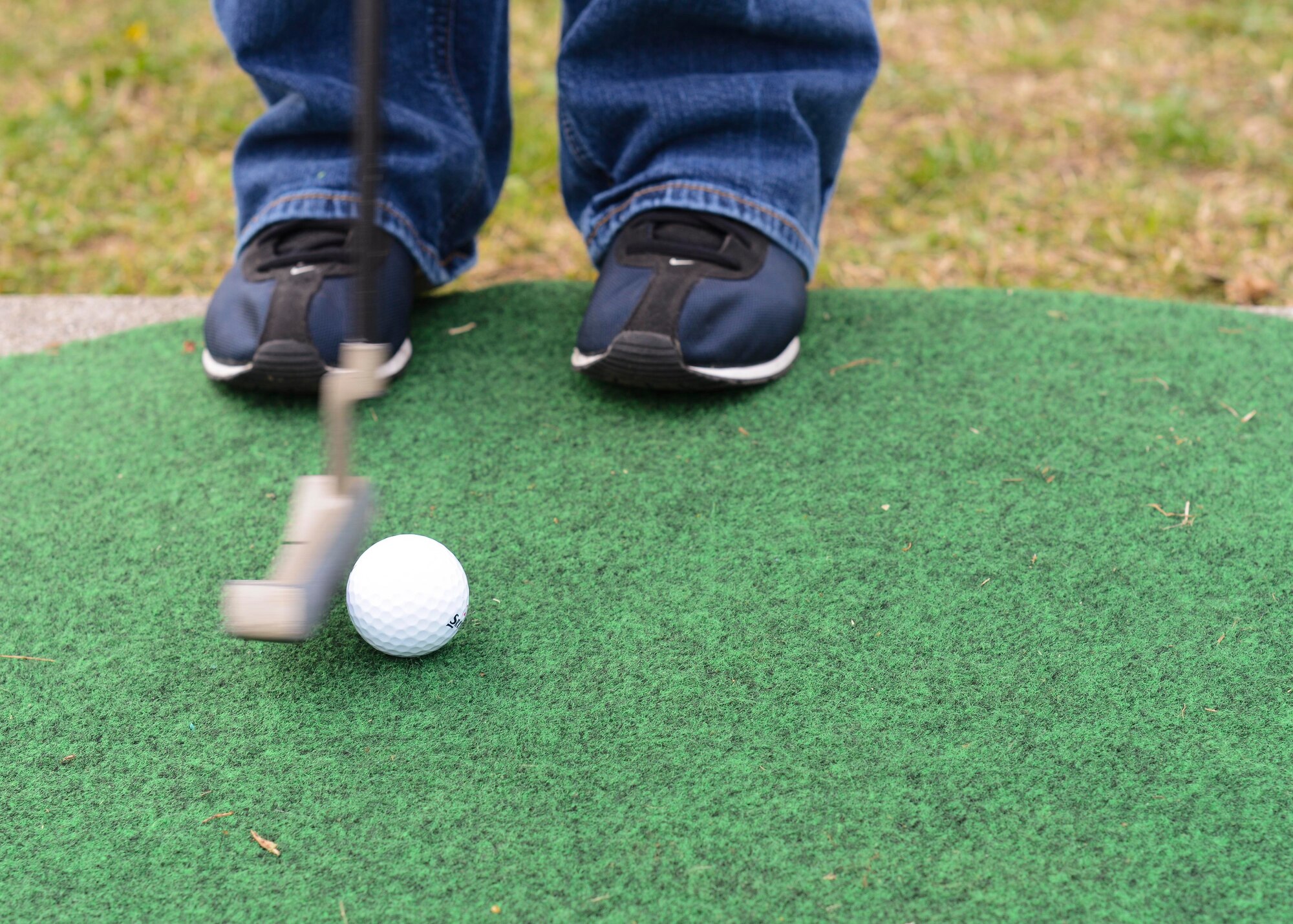 A Wyvern youth putts a golf ball during a game of mini golf at a Month of the Military Child and Autism Awareness Carnival, April 2, 2016, at Aviano Air Base, Italy. The event hosted games and activities designed to bring families together to enhance the Aviano community. (U.S. Air Force photo by Senior Airman Austin Harvill/Released)