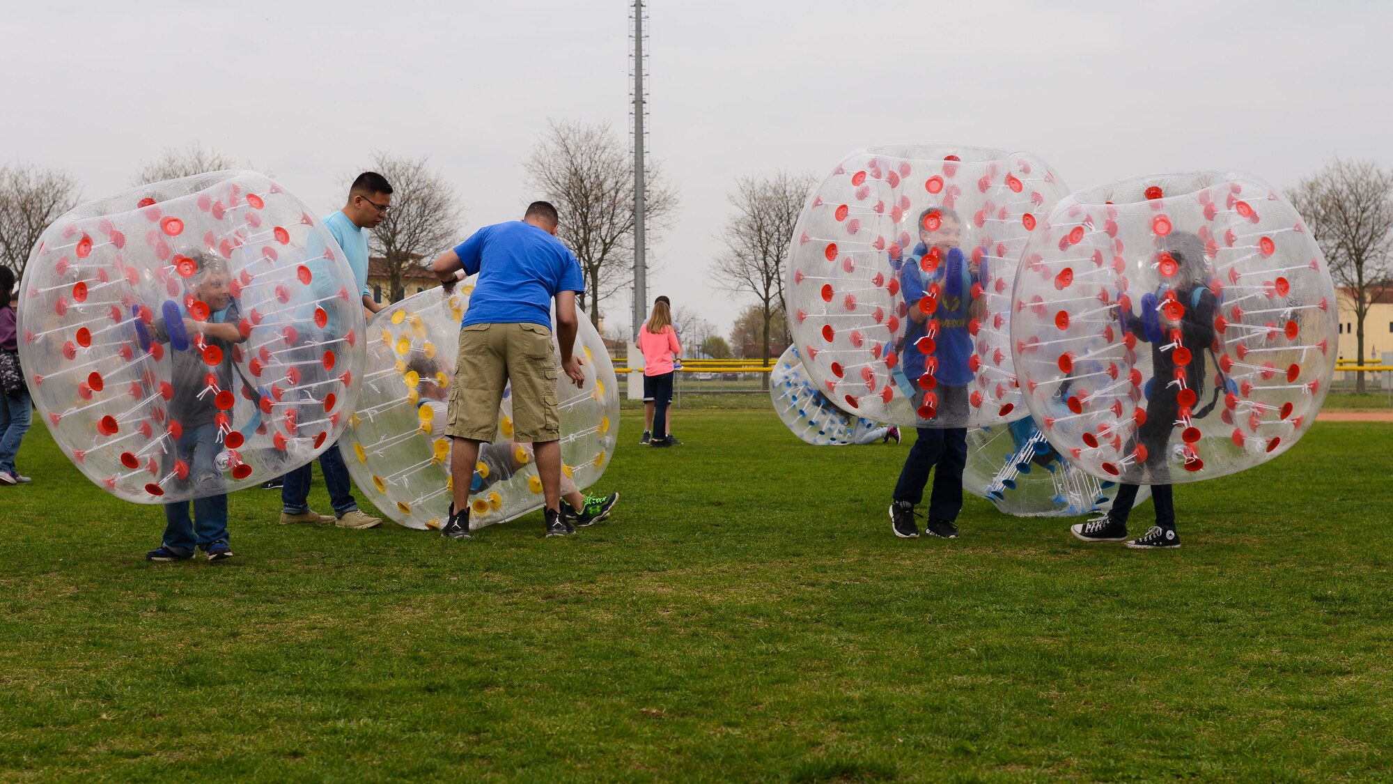 Children play in bubble balls during a Month of the Military Child and Autism Awareness Carnival, April 2, 2016, at Aviano Air Base, Italy. Multiple agencies that revolve around Aviano children, like the Boy Scouts and child development centers, hosted games and other activities for event participants. (U.S. Air Force photo by Senior Airman Austin Harvill/Released)