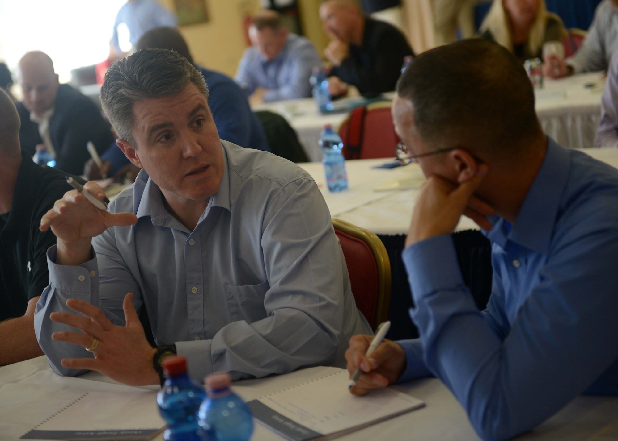 (From left) Lt. Col. Matthew Busch, 31 Fighter wing director of staff, and Chief Master Sergeant Michael Brown, 31st Mission Support Group chief enlisted manager, participate in an off-site conference to help further develop and improve as a wing and individually as Air Force leaders, March 29 to 31, 2016, at Camp Darby, Italy. The conference was focused on three components; heritage, leadership development and a 731st Munitions Squadron mission overview. (U.S. Air Force photo by Staff Sgt. Evelyn Chavez/Released)
