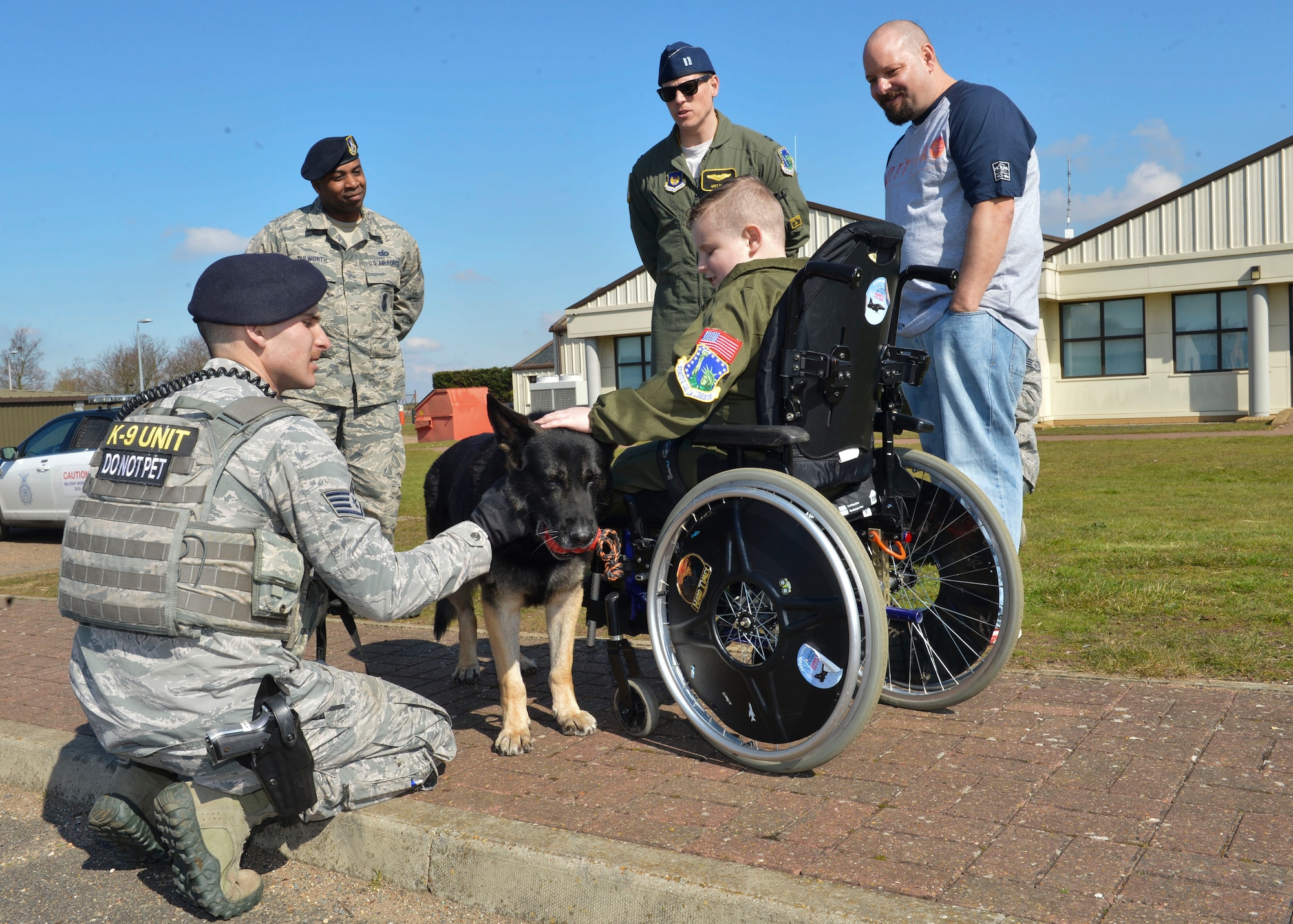 Carson Jones, a seven-year-old “Pilot for a Day” participant, visits 48th Security Forces Squadron military working dogs during a tour at Royal Air Force Lakenheath, England, March 31, 2016. Carson learned what each dog’s mission is on base and was able to see a working dog display. (U.S. Air Force photo/Senior Airman Nigel Sandridge)