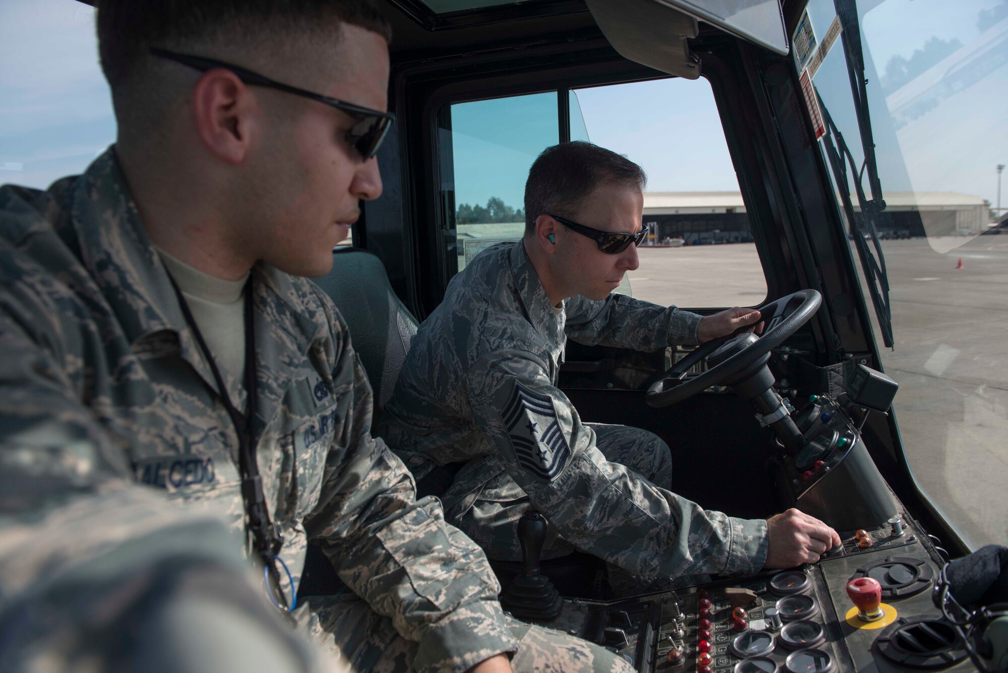 U.S. Air Force Chief Master Sgt. Mark Redden, 521st Air Mobility Operations Wing command chief, starts a U-30 aircraft tow vehicle while U.S. Air Force Staff Sgt. Michael Salcedo, 728th Air Mobility Squadron crew chief, monitors him, April 5, 2016, at Incirlik Air Base, Turkey. During his visit, Redden toured the 728th AMS facilities and interacted with Airmen throughout the day. (U.S. Air Force photo by Senior Airman John Nieves Camacho/Released)