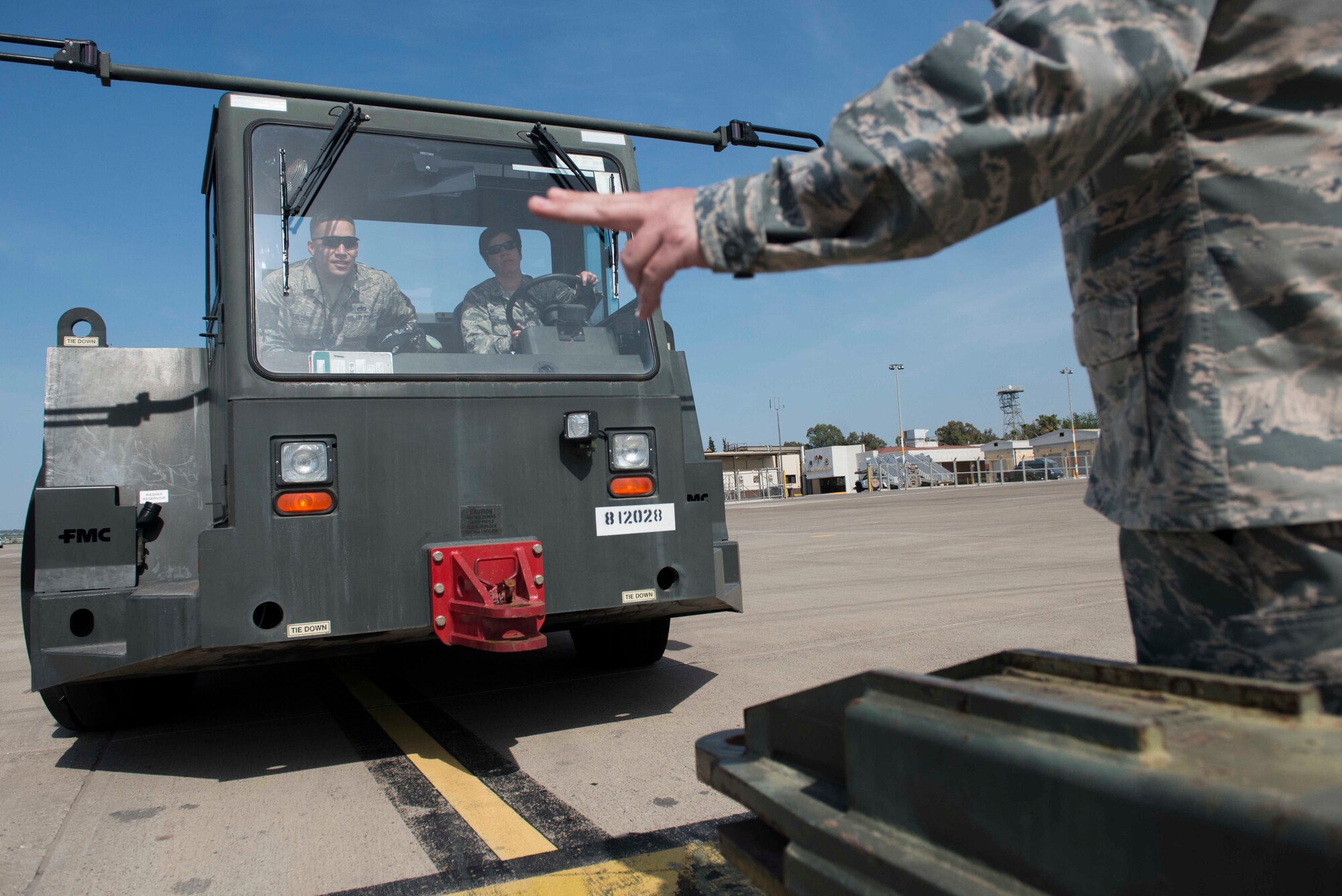 U.S. Air Force Staff Sgt. Michael Salcedo, 728th Air Mobility Squadron crew chief, oversees U.S. Air Force Col. Nancy Bozzer, 521st Air Mobility Operations Wing commander, as she operates a U-30 aircraft tow vehicle, April 5, 2016, at Incirlik Air Base, Turkey. Bozzer briefly drove the U-30 to get a feel for the procedures 728th Airmen perform. (U.S. Air Force photo by Senior Airman John Nieves Camacho/Released)