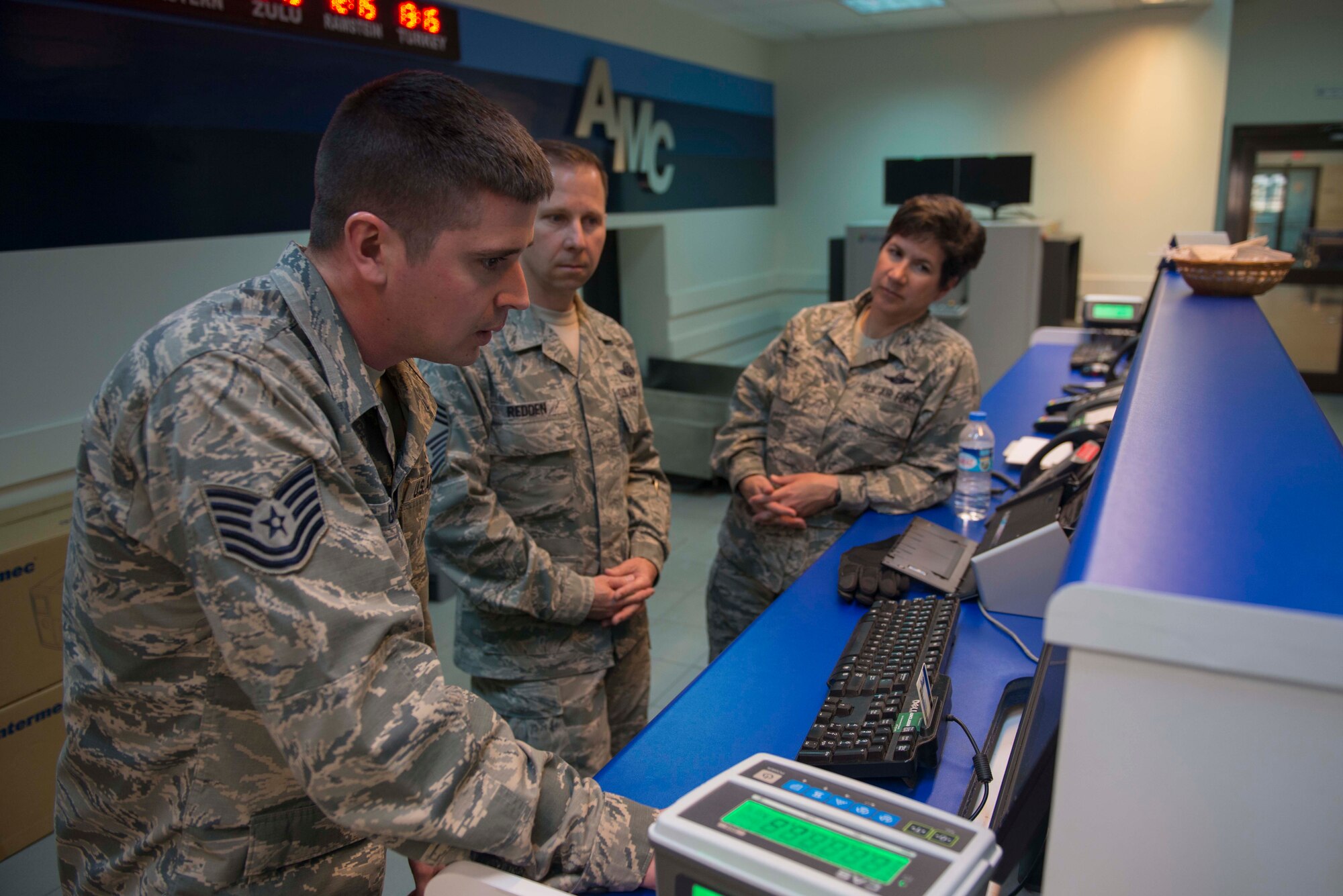 U.S. Air Force Tech. Sgt. Steven Gray, 728th Air Mobility Squadron passenger service supervisor, explains passenger terminal procedures to U.S. Air Force Chief Master Sgt. Mark Redden, 521st Air Mobility Operations Wing command chief, and U.S. Air Force Col. Nancy Bozzer, 521st AMOW commander, April 4, 2016, at Incirlik Air Base, Turkey. During their visit, Bozzer and Redden toured the 728th AMS facilities and interacted with Airmen throughout the day. (U.S. Air Force photo by Senior Airman John Nieves Camacho/Released)